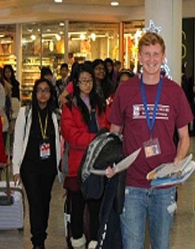 A Churchill House representative meeting students at the airport